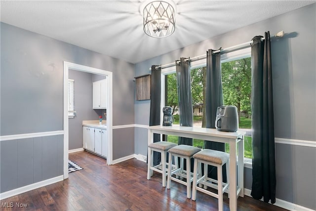 1558 Windcrest St NW, North Canton, OH 44720 - dining room featuring dark wood finished floors and a chandelier