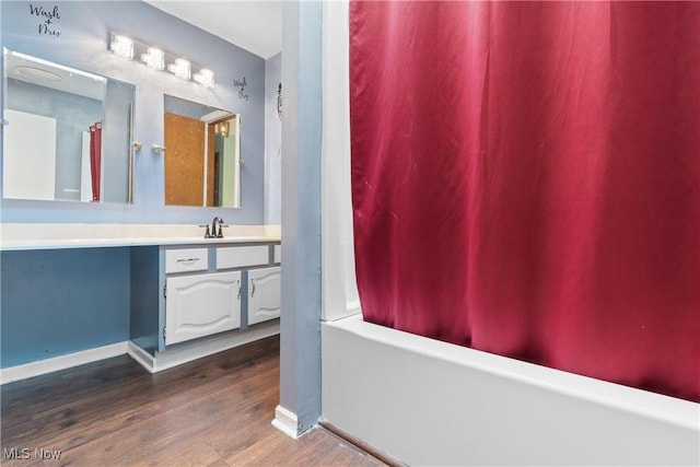 1558 Windcrest St NW, North Canton, OH 44720 - bathroom with wood finished floors, vanity, and shower / bath combination with curtain
