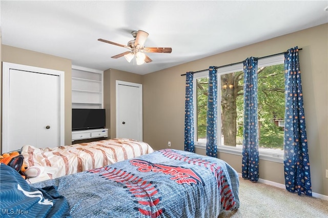 1558 Windcrest St NW, North Canton, OH 44720 - carpeted bedroom featuring multiple closets and a ceiling fan
