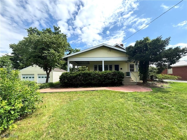 1709 Washington Blvd, Belpre, OH 45714 - view of front facade with a front yard and a garage