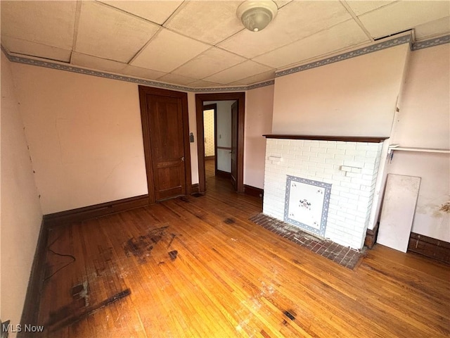 1709 Washington Blvd, Belpre, OH 45714 - unfurnished living room featuring hardwood / wood-style flooring, a fireplace, and a drop ceiling