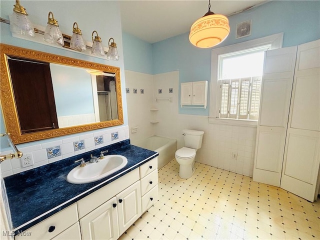 1709 Washington Blvd, Belpre, OH 45714 - full bathroom featuring vanity, tile patterned floors, and tile walls