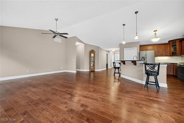 498 Water Pointe Ln, Brunswick, OH 44212 - kitchen with appliances with stainless steel finishes, a breakfast bar, dark wood-style flooring, open floor plan, and vaulted ceiling