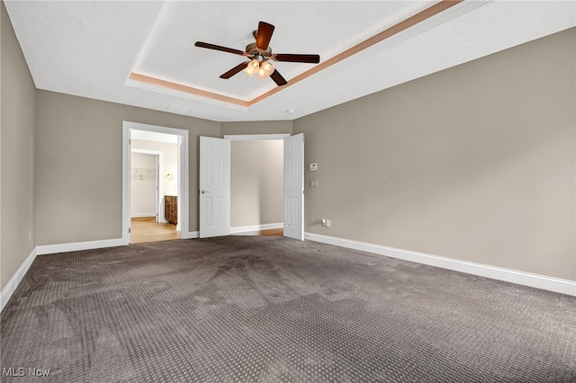 498 Water Pointe Ln, Brunswick, OH 44212 - unfurnished bedroom featuring a tray ceiling, carpet floors, ceiling fan, and connected bathroom