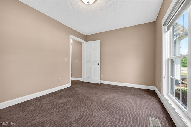 498 Water Pointe Ln, Brunswick, OH 44212 - spare room featuring dark colored carpet and a textured ceiling