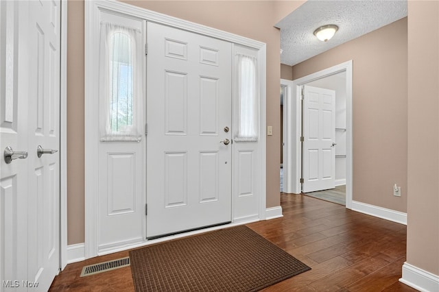498 Water Pointe Ln, Brunswick, OH 44212 - entryway with a textured ceiling and dark wood-style flooring