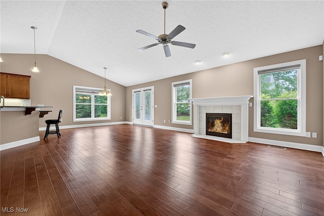 498 Water Pointe Ln, Brunswick, OH 44212 - unfurnished living room with a ceiling fan, vaulted ceiling, a textured ceiling, plenty of natural light, and a fireplace