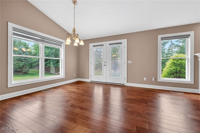 498 Water Pointe Ln, Brunswick, OH 44212 - spare room with a chandelier, plenty of natural light, vaulted ceiling, dark wood-style flooring, and french doors