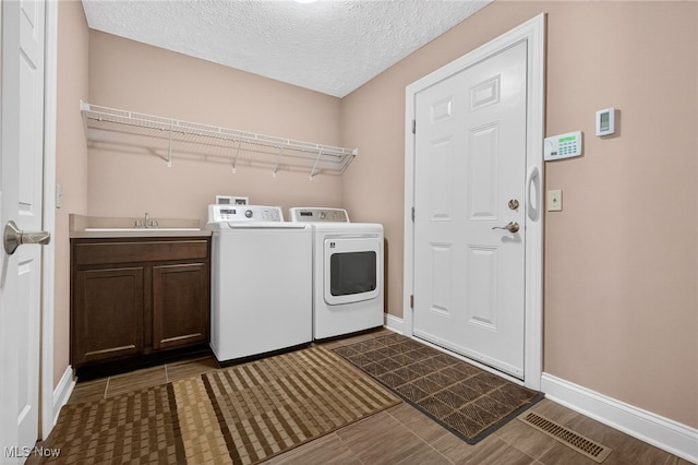 498 Water Pointe Ln, Brunswick, OH 44212 - washroom with independent washer and dryer, cabinet space, and a textured ceiling
