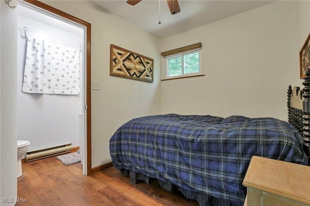 11140 Andrus Dr, Glouster, OH 45732 - bedroom with a baseboard heating unit, wood finished floors, and ceiling fan