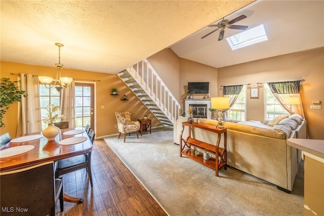1870 E 223rd St, Euclid, OH 44117 - living room featuring stairs, a chandelier, vaulted ceiling, a skylight, and ceiling fan