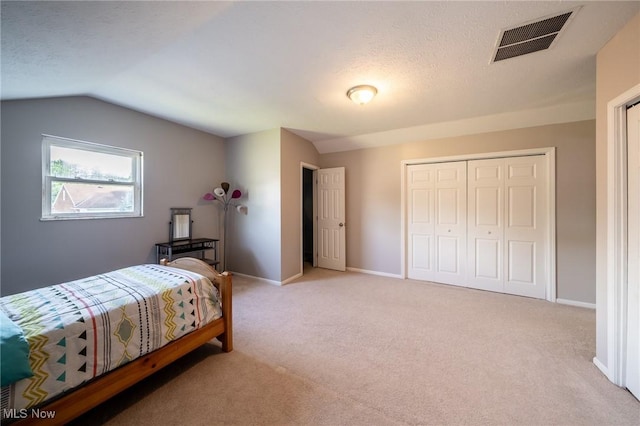 1870 E 223rd St, Euclid, OH 44117 - bedroom featuring light colored carpet, lofted ceiling, a closet, and a textured ceiling