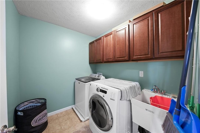 8028 Megan Meadow Dr, Hudson, OH 44236 - laundry area with separate washer and dryer, cabinet space, and a textured ceiling