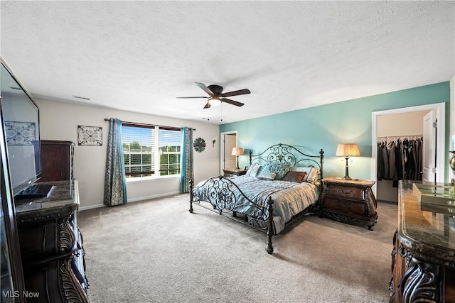 8028 Megan Meadow Dr, Hudson, OH 44236 - bedroom with carpet flooring, a spacious closet, a textured ceiling, and ceiling fan