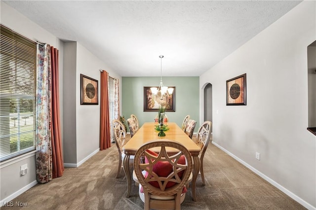 8028 Megan Meadow Dr, Hudson, OH 44236 - dining area featuring arched walkways, carpet, and a chandelier
