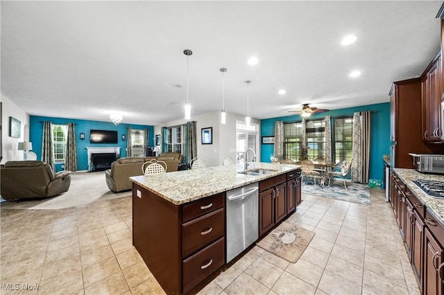 8028 Megan Meadow Dr, Hudson, OH 44236 - kitchen with appliances with stainless steel finishes, recessed lighting, open floor plan, an island with sink, and a fireplace