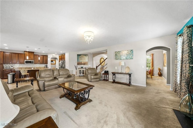 8028 Megan Meadow Dr, Hudson, OH 44236 - living area featuring arched walkways, light colored carpet, and recessed lighting