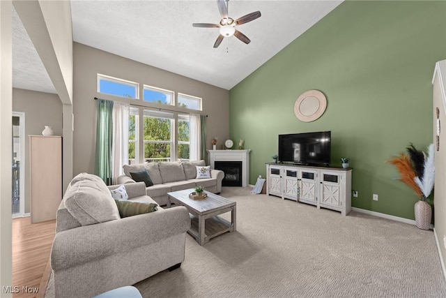 866 Brightwood Ct, Brunswick, OH 44212 - living area with high vaulted ceiling, ceiling fan, and a glass covered fireplace