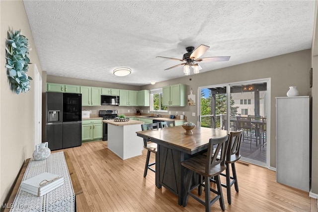 866 Brightwood Ct, Brunswick, OH 44212 - kitchen with appliances with stainless steel finishes, green cabinetry, light wood-style floors, ceiling fan, and light countertops