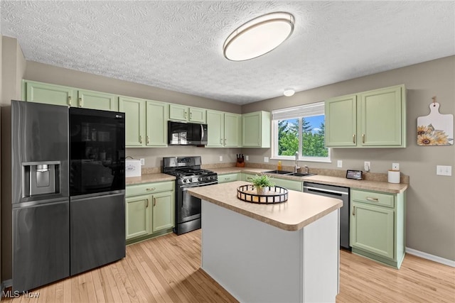 866 Brightwood Ct, Brunswick, OH 44212 - kitchen featuring stainless steel appliances, green cabinetry, light countertops, light wood-style floors, and a textured ceiling