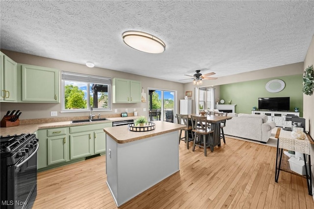 866 Brightwood Ct, Brunswick, OH 44212 - kitchen featuring green cabinets, black range with gas cooktop, light countertops, ceiling fan, and light wood-type flooring