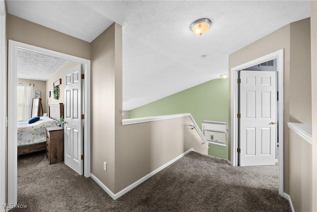 866 Brightwood Ct, Brunswick, OH 44212 - hallway with an upstairs landing, carpet, lofted ceiling, and a textured ceiling