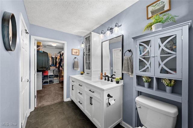 866 Brightwood Ct, Brunswick, OH 44212 - bathroom featuring vanity, a spacious closet, and a textured ceiling