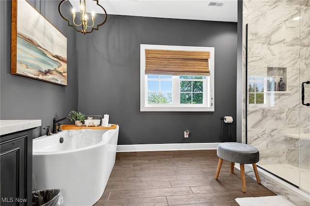14370 Washington Blvd, University Heights, OH 44118 - full bath featuring a soaking tub, a marble finish shower, hardwood / wood-style floors, vanity, and a chandelier
