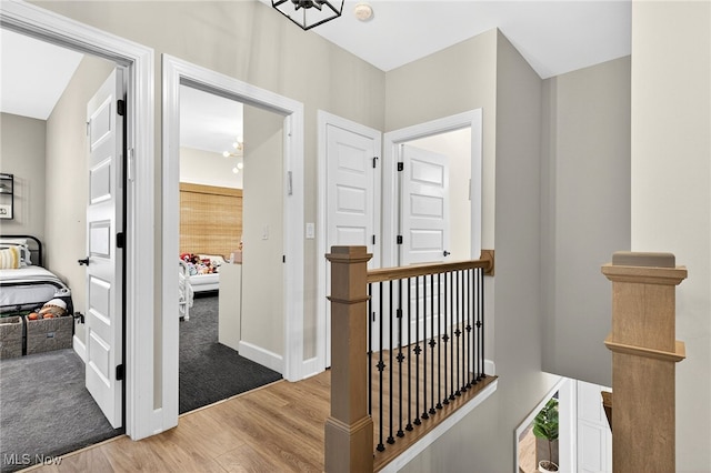 14370 Washington Blvd, University Heights, OH 44118 - corridor with an upstairs landing, light wood finished floors, and a chandelier