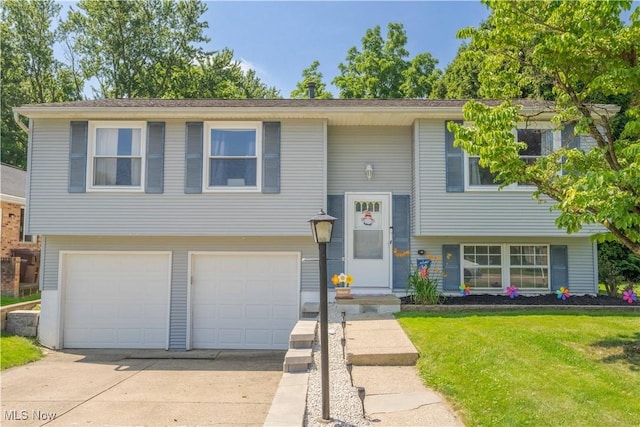 4950 Trafalgar St SW, Canton, OH 44706 - bi-level home with a garage, concrete driveway, and a front yard