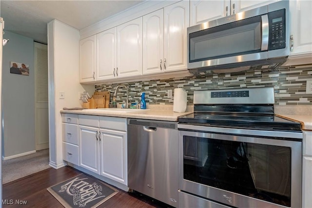 4950 Trafalgar St SW, Canton, OH 44706 - kitchen featuring stainless steel appliances, white cabinets, light countertops, and backsplash
