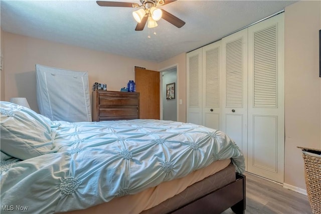 4950 Trafalgar St SW, Canton, OH 44706 - bedroom with wood finished floors, a closet, and a ceiling fan