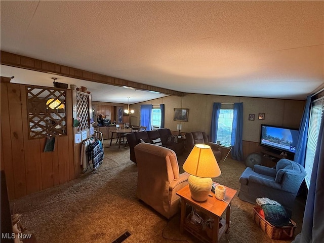 44534 US Highway 36, Coshocton, OH 43812 - carpeted living room featuring a textured ceiling, wooden walls, and a chandelier