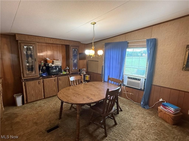 44534 US Highway 36, Coshocton, OH 43812 - dining area with carpet floors, wood walls, cooling unit, vaulted ceiling, and a chandelier
