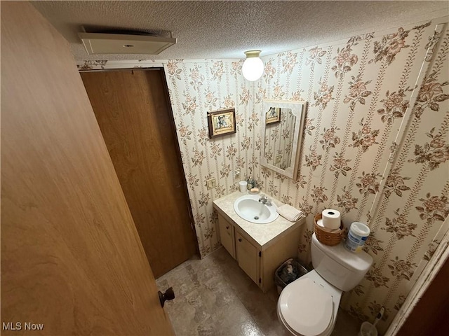 44534 US Highway 36, Coshocton, OH 43812 - bathroom featuring vanity, a textured ceiling, and wallpapered walls