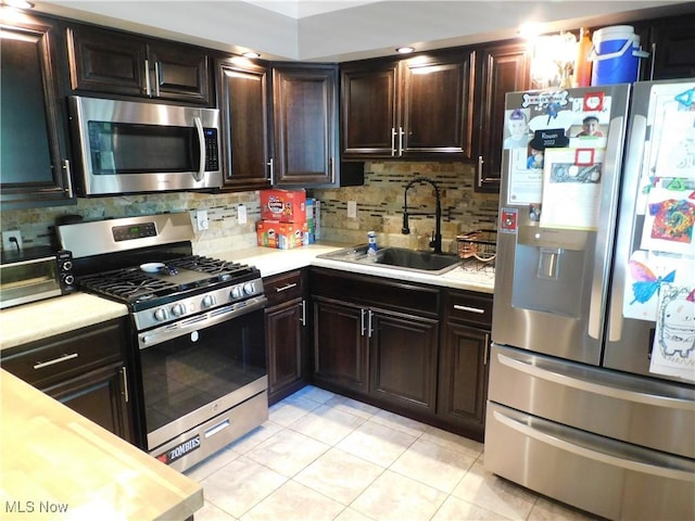 2804 Avon Blvd, Ashtabula, OH 44004 - kitchen featuring appliances with stainless steel finishes, light countertops, light tile patterned floors, and decorative backsplash