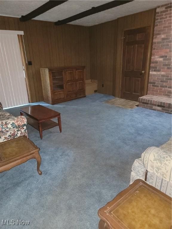 5622 Donna Dr, Ashtabula, OH 44004 - living room with wood walls, carpet floors, beam ceiling, and a textured ceiling