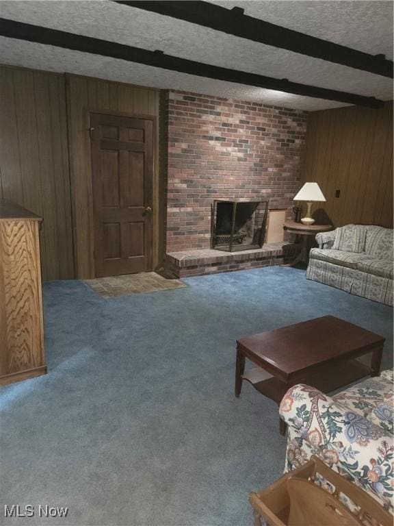 5622 Donna Dr, Ashtabula, OH 44004 - living room with wood walls, carpet floors, beamed ceiling, a brick fireplace, and a textured ceiling