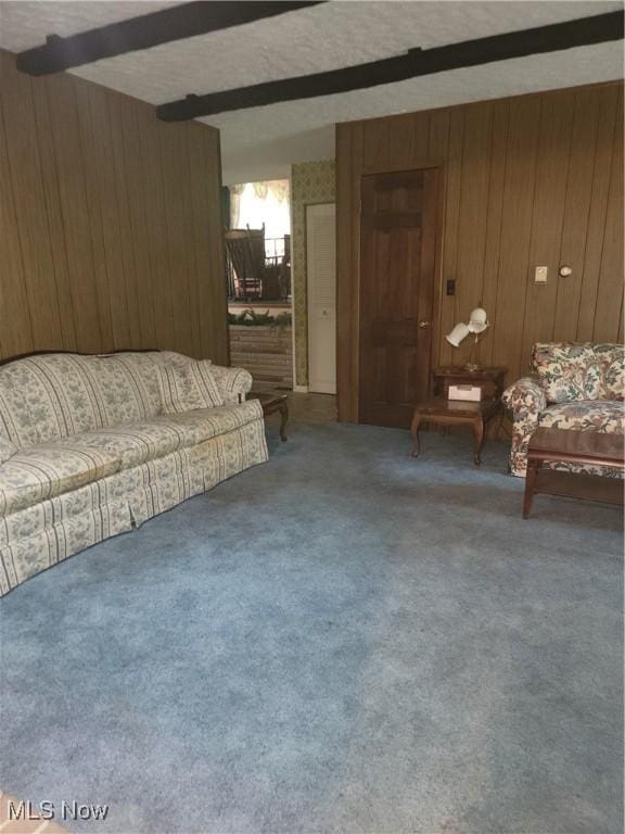 5622 Donna Dr, Ashtabula, OH 44004 - living room with wood walls, beam ceiling, and carpet floors