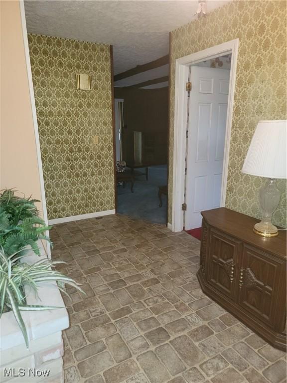 5622 Donna Dr, Ashtabula, OH 44004 - hallway featuring wallpapered walls and brick patterned flooring