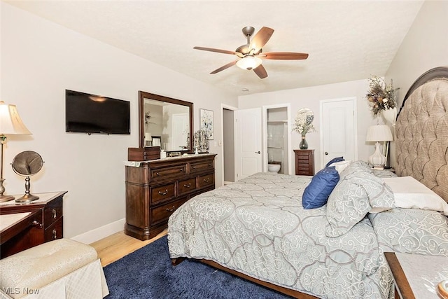 7148 N Brewster Pl, Concord, OH 44077 - bedroom with connected bathroom, ceiling fan, and light wood finished floors