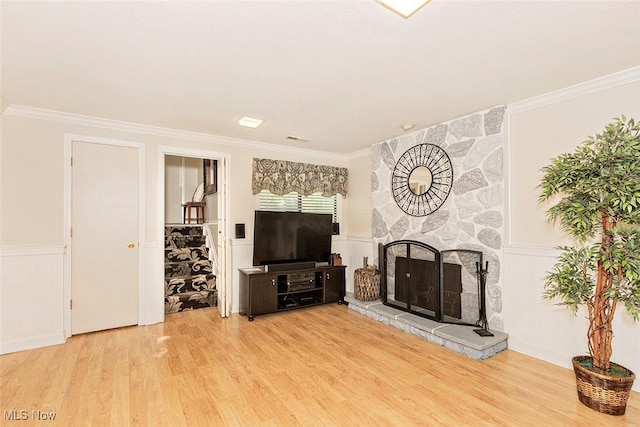 7148 N Brewster Pl, Concord, OH 44077 - unfurnished living room with ornamental molding, wood finished floors, a fireplace, wainscoting, and a decorative wall