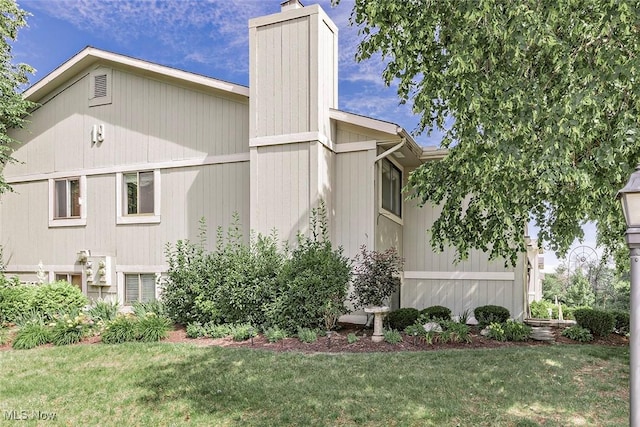 7148 N Brewster Pl, Concord, OH 44077 - view of property exterior featuring a chimney and a lawn