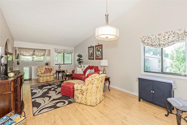7148 N Brewster Pl, Concord, OH 44077 - living room featuring light wood-style floors, vaulted ceiling, and arched walkways