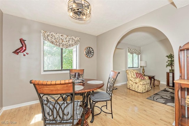 7148 N Brewster Pl, Concord, OH 44077 - dining room featuring arched walkways and wood finished floors