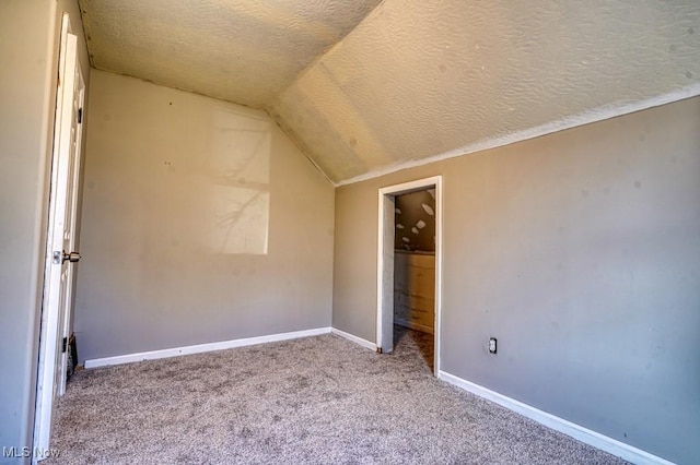 2613 Oakdale Ave, Lorain, OH 44055 - unfurnished bedroom featuring a textured ceiling, lofted ceiling, and carpet floors