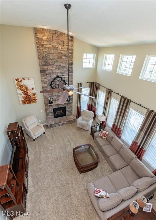 3139 Junior Pkwy, Brunswick, OH 44212 - living area with carpet, plenty of natural light, a stone fireplace, and a towering ceiling