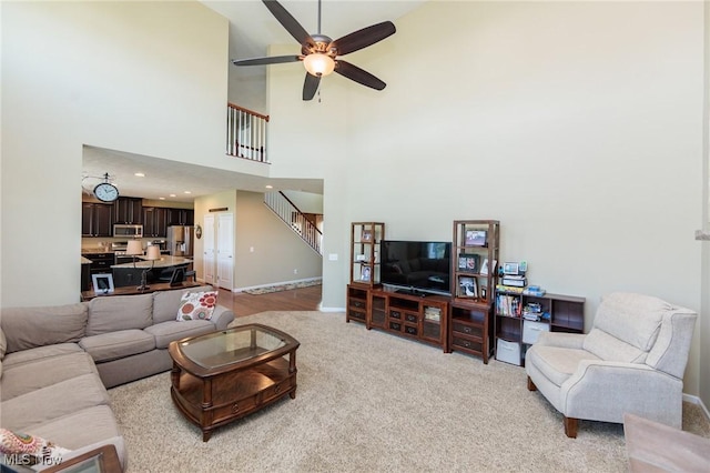 3139 Junior Pkwy, Brunswick, OH 44212 - living area with stairway, ceiling fan, light colored carpet, and high vaulted ceiling