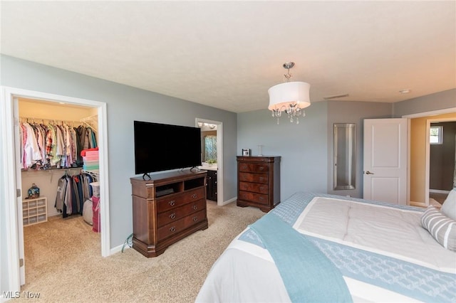 3139 Junior Pkwy, Brunswick, OH 44212 - bedroom with a spacious closet, light colored carpet, a closet, and a chandelier