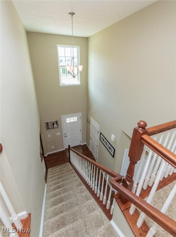 3139 Junior Pkwy, Brunswick, OH 44212 - stairway with a chandelier, a towering ceiling, and carpet flooring